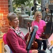 Belleville Philharmonic Orchestra, two women holding violins. 