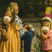 Belleville Heart Garden Harvest Festival. Two small children sniffing white pumpkins.