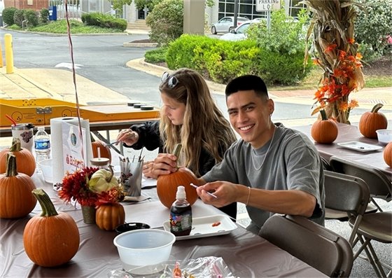 People painting pumpkins at the Belleville 2023 Oktoberfest.