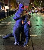 Two people in Godzilla costumes posing at Belleville's 2023 Main Street Trick or Treat event