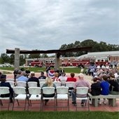 Belleville, IL 2023 9/11 Ceremony. A crowd of people seated around the 9/11 memorial.