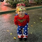 A small child poses in a Wonder Woman costume at Belleville's 2023 Trick or Treat event