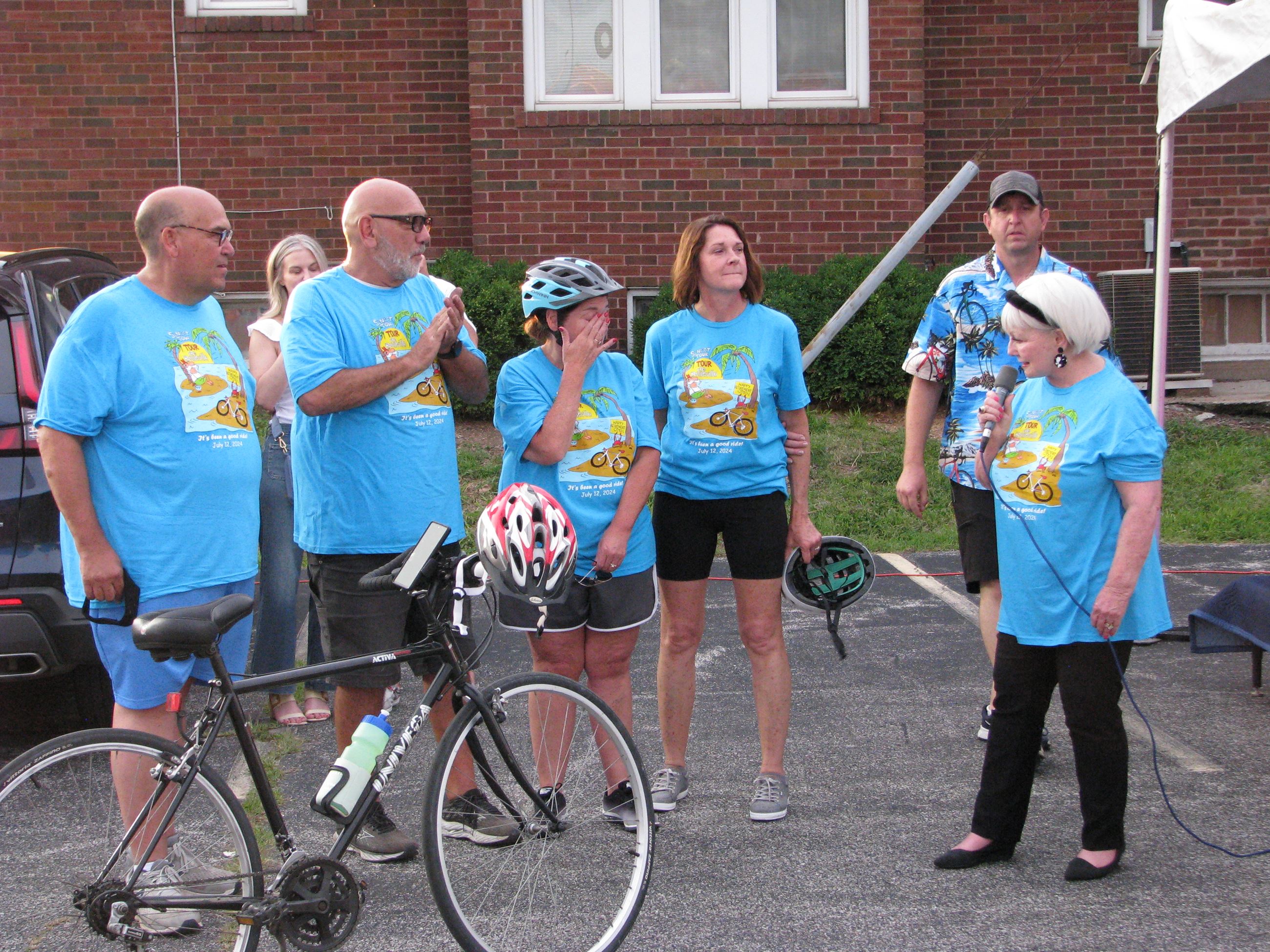 Mayor Patty Gregory in t-shirt speaking before Tour de Belleville with founders